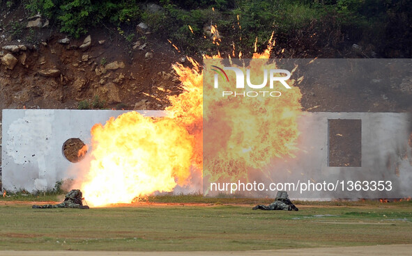 Soldiers present their chemical defense techniques and tactics during an anti-terrorism drill in Fusui County of Chongzuo City, south China'...