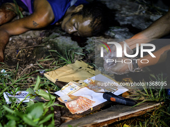 (EDITORS NOTE: Image depicts graphic content.) A police investigator shows recovered sachets of crystal meth known locally as "shabu" and ca...