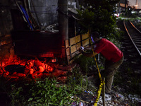 (EDITORS NOTE: Image depicts graphic content.) A member of the police's homicide division takes pictures of the corpse of a suspected drug p...