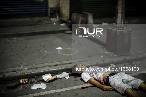 (EDITORS NOTE: Image depicts graphic content.) The corpse of a suspected drug pusher lies on a street after he was shot dead by unidentified...