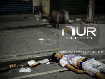 (EDITORS NOTE: Image depicts graphic content.) The corpse of a suspected drug pusher lies on a street after he was shot dead by unidentified...