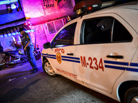 A police officer stands guard outside a house where three suspected drug pushers were shot dead following a police operation in Manila, Phil...