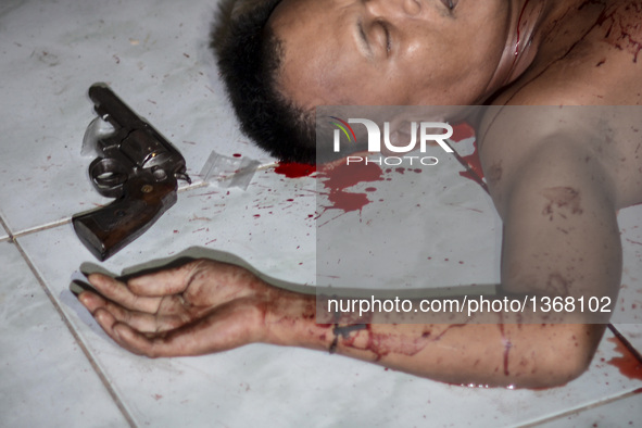 (EDITORS NOTE: Image depicts graphic content.) A sachet of crystal meth known locally as "shabu" and a revolver lies next to the corpse of a...