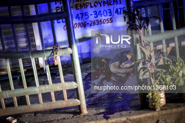 (EDITORS NOTE: Image depicts graphic content.) The corpse of a suspected drug addict lies on a street after he was shot dead by unidentified...