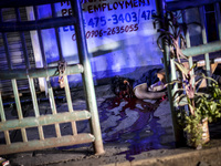 (EDITORS NOTE: Image depicts graphic content.) The corpse of a suspected drug addict lies on a street after he was shot dead by unidentified...