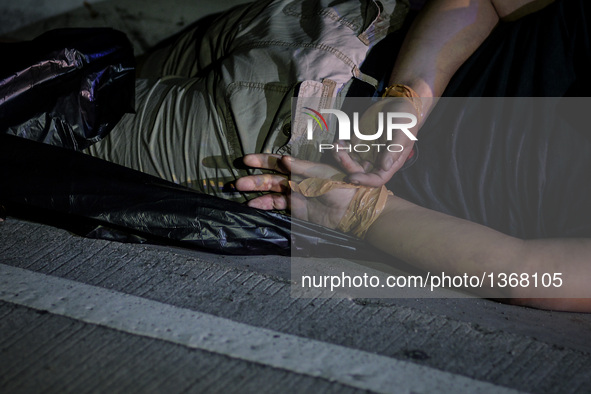 (EDITORS NOTE: Image depicts graphic content.) The corpse of a suspected drug addict and victim of a vigilante-style execution with his hand...