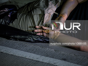 (EDITORS NOTE: Image depicts graphic content.) The corpse of a suspected drug addict and victim of a vigilante-style execution with his hand...