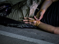 (EDITORS NOTE: Image depicts graphic content.) The corpse of a suspected drug addict and victim of a vigilante-style execution with his hand...