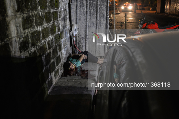 (EDITORS NOTE: Image depicts graphic content.) The corpse of a suspected drug pusher and victim of a vigilante-style execution with his limb...