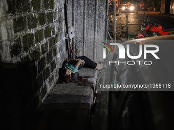 (EDITORS NOTE: Image depicts graphic content.) The corpse of a suspected drug pusher and victim of a vigilante-style execution with his limb...