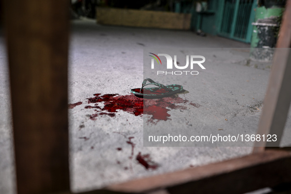 (EDITORS NOTE: Image depicts graphic content.) A slipper and blood from a police officer who was shot following a police anti-drugs operatio...