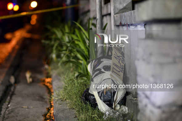 (EDITORS NOTE: Image depicts graphic content.) The corpse of a suspected drug pusher and victim of a vigilante-style execution with his body...