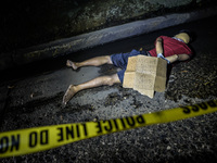 (EDITORS NOTE: Image depicts graphic content.) The corpse of a suspected drug pusher and victim of a vigilante-style execution with his hand...