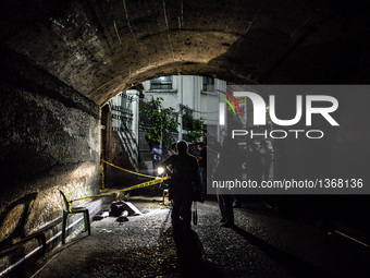 (EDITORS NOTE: Image depicts graphic content.) Police and media inspect the corpse of a suspected drug pusher and victim of a vigilante-styl...