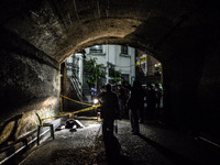 (EDITORS NOTE: Image depicts graphic content.) Police and media inspect the corpse of a suspected drug pusher and victim of a vigilante-styl...