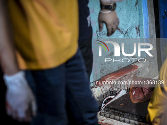 (EDITORS NOTE: Image depicts graphic content.) Blood drips from inside a house where suspected drug pushers were shot dead following a polic...