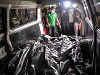 (EDITORS NOTE: Image depicts graphic content.) Body bags containing the corpses of suspected drug pushers are seen inside a van after they w...