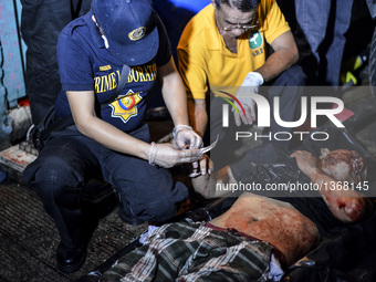 (EDITORS NOTE: Image depicts graphic content.) A police investigator collects fingerprints from a corpse of a suspected drug pusher after he...