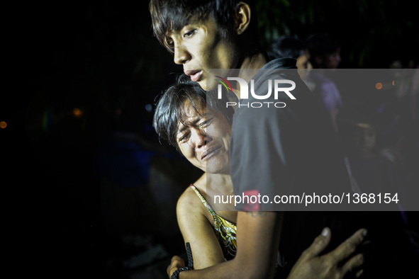 (EDITORS NOTE: Image depicts graphic content.) Relatives of a suspected drug pusher weep after he was shot dead following a police operation...