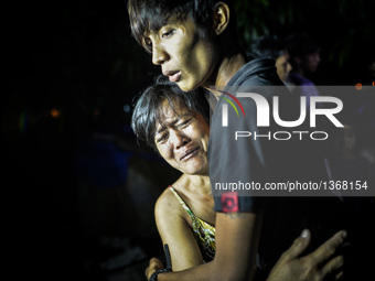 (EDITORS NOTE: Image depicts graphic content.) Relatives of a suspected drug pusher weep after he was shot dead following a police operation...