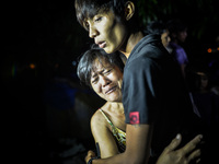 (EDITORS NOTE: Image depicts graphic content.) Relatives of a suspected drug pusher weep after he was shot dead following a police operation...