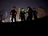 (EDITORS NOTE: Image depicts graphic content.) Police officers stand guard near a crime scene where a suspected drug pusher was shot dead fo...