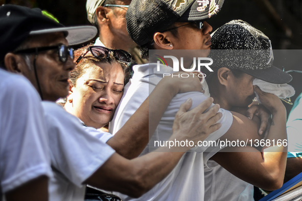 Relatives of a suspected drug pusher and victim of a vigilante-style execution grieve during a burial ceremony in Pasay, south of Manila, Ph...