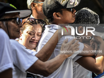 Relatives of a suspected drug pusher and victim of a vigilante-style execution grieve during a burial ceremony in Pasay, south of Manila, Ph...