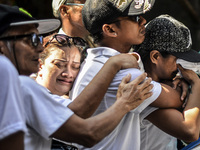 Relatives of a suspected drug pusher and victim of a vigilante-style execution grieve during a burial ceremony in Pasay, south of Manila, Ph...