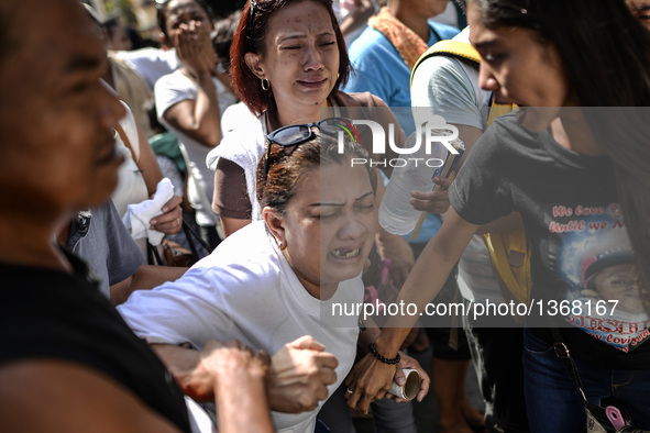 Relatives of a suspected drug pusher and victim of a vigilante-style execution grieve during a burial ceremony in Pasay, south of Manila, Ph...