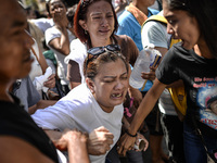 Relatives of a suspected drug pusher and victim of a vigilante-style execution grieve during a burial ceremony in Pasay, south of Manila, Ph...