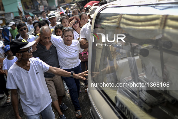 Relatives of a suspected drug pusher and victim of a vigilante-style execution grieve during a burial ceremony in Pasay, south of Manila, Ph...