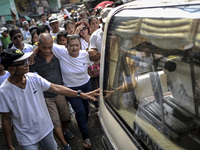 Relatives of a suspected drug pusher and victim of a vigilante-style execution grieve during a burial ceremony in Pasay, south of Manila, Ph...