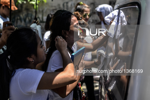 The wife of a suspected drug pusher and victim of a vigilante-style execution grieves during a burial ceremony in Pasay, south of Manila, Ph...