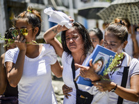 (EDITORS NOTE: Image depicts graphic content.) Relatives of a suspected drug pusher and victim of a vigilante-style execution grieve during...