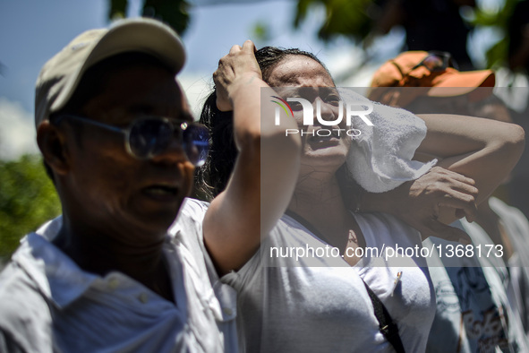 The wife of a suspected drug pusher and victim of a vigilante-style execution grieves during a burial ceremony in Pasay, south of Manila, Ph...