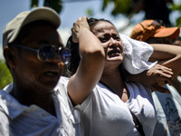 The wife of a suspected drug pusher and victim of a vigilante-style execution grieves during a burial ceremony in Pasay, south of Manila, Ph...