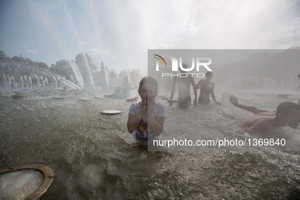 Children cool down while playing in a fountain in Moscow, Russia, on Aug. 2, 2016.