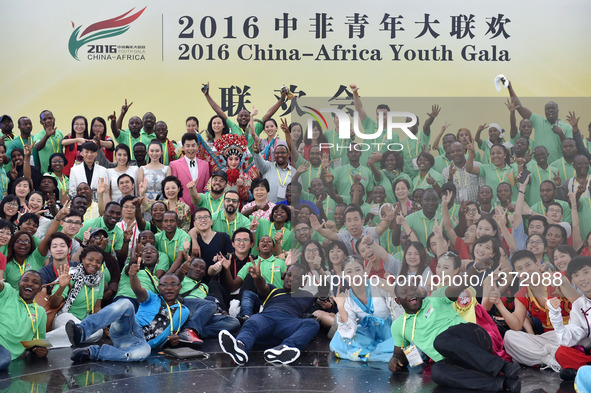 Participants pose for a group photo at the 2016 China-Africa Youth Gala in Guangzhou, capital of south China's Guangdong Province, Aug. 4, 2...