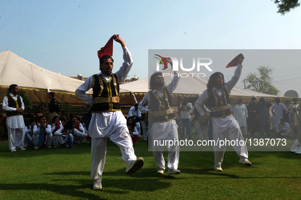 Pakistani men perform traditional dance during a ceremony to mark Pakistan's Independence Day in northwest Pakistan's Peshawar on Aug. 14, 2...