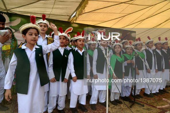 Pakistani children sing national anthem during a ceremony to mark Pakistan's Independence Day in northwest Pakistan's Peshawar on Aug. 14, 2...