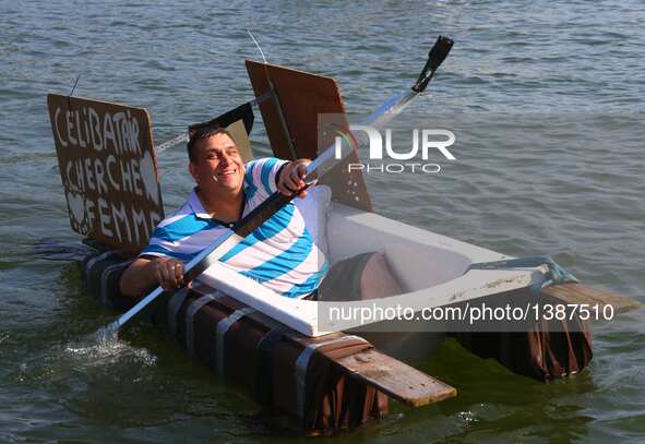 A participant takes part in the International Bathtub Regatta on the Meuse River in Dinant, southern Belgium on Aug. 15, 2016. Starting in 1...