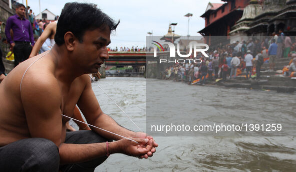 A Hindu devotee offers prayers during the Janai Purnima Festival in Kathmandu, Nepal, Aug. 18, 2016. Janai Purnima, also known as the festiv...