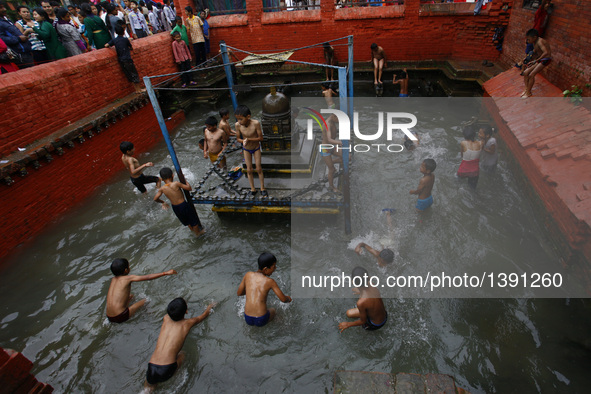 Nepalese boys swim in a holy pond during Janai Purnima Festival at Lalitpur, Nepal, Aug. 18, 2016. Janai Purnima, also known as the festival...