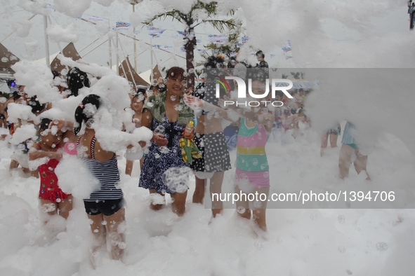 People participate in a bubble carnival at a water park in Yantai, east China's Shandong Province, Aug. 19, 2016.