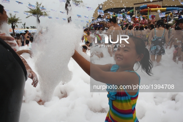 People participate in a bubble carnival at a water park in Yantai, east China's Shandong Province, Aug. 19, 2016.