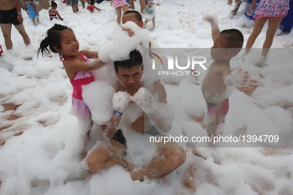 People participate in a bubble carnival at a water park in Yantai, east China's Shandong Province, Aug. 19, 2016.