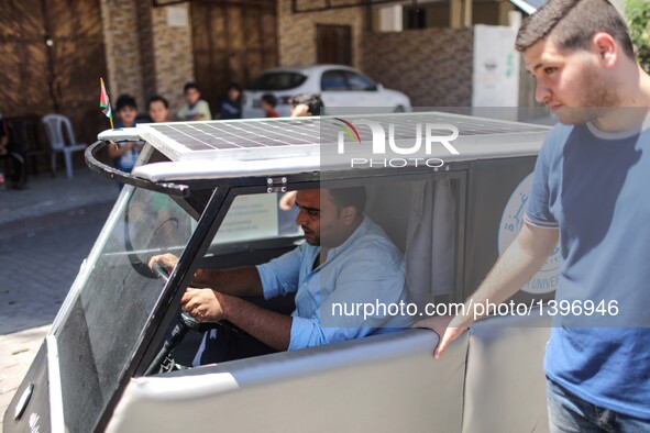 Palestinian students Jamal Mikaty (L) and Khaled Bardawil try their solar car in Gaza City, on Aug. 16, 2016. Two Palestinian mechanical eng...