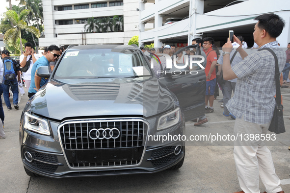 People attend an auction of seized luxury cars at the Thai Customs headquarters in Bangkok Aug. 23, 2016. A total of 343 seized luxury cars...