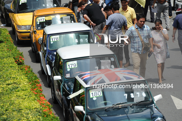 People attend an auction of seized luxury cars at the Thai Customs headquarters in Bangkok Aug. 23, 2016. A total of 343 seized luxury cars...